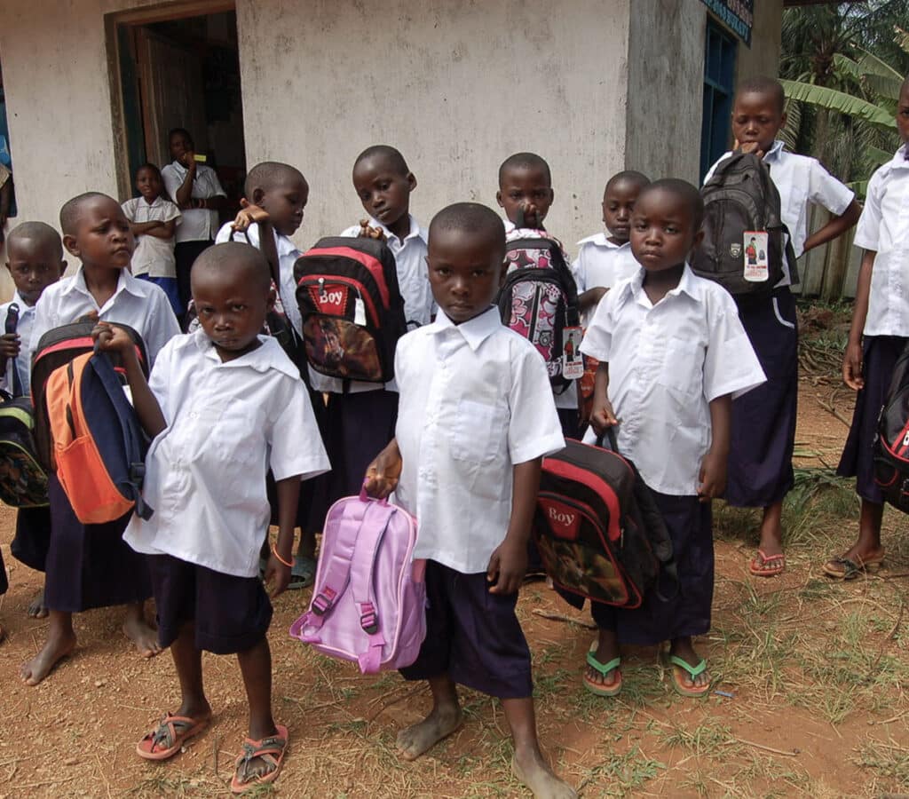 group photo of kids holding backpacks